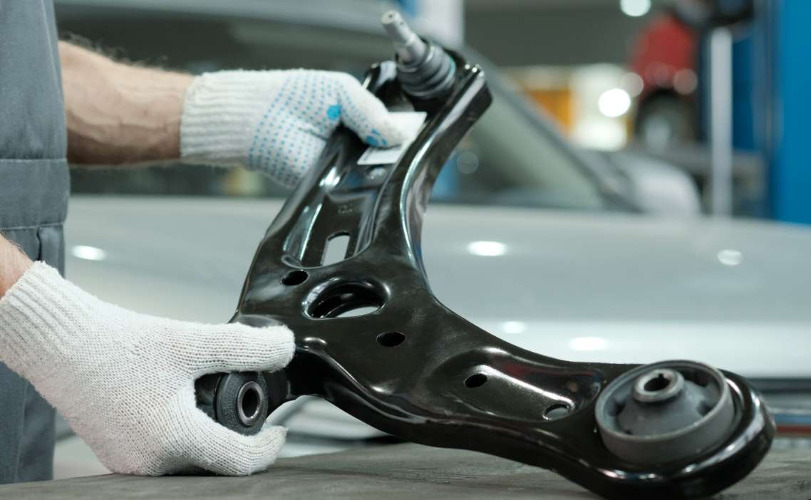 Mechanic holding car parts